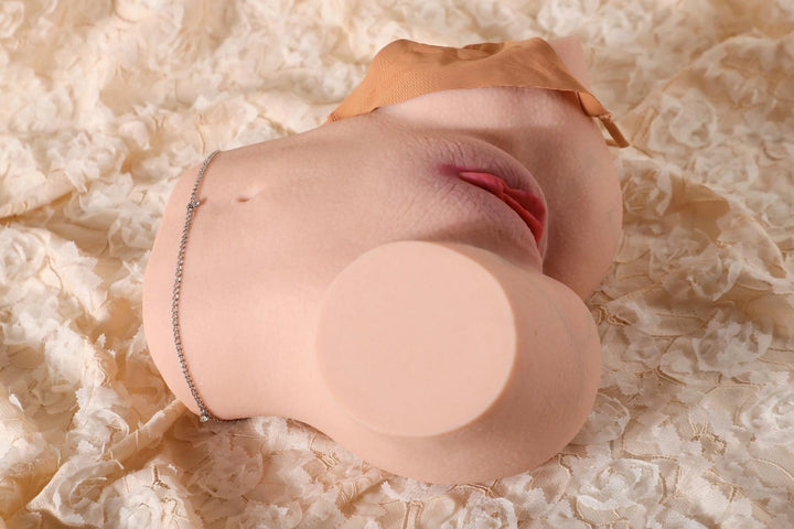 Sexpuppen-Torso auf Spitzenstoff