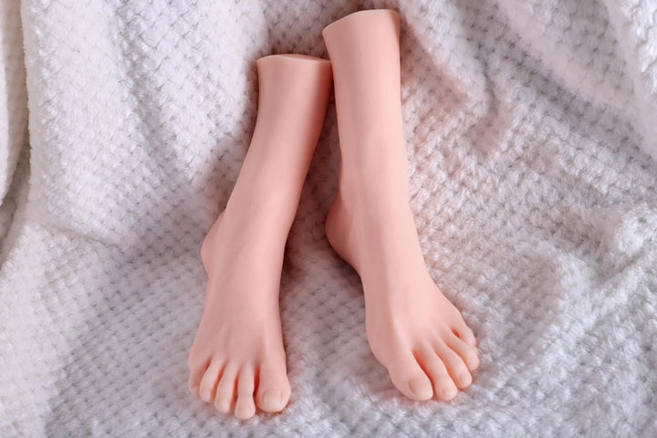Sexpuppen Füße auf weißem Stoff