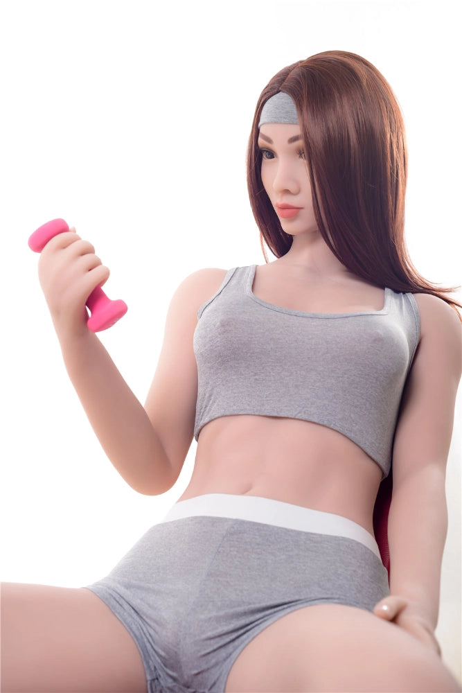 Sexpuppe mit Hantel in Sportkleidung