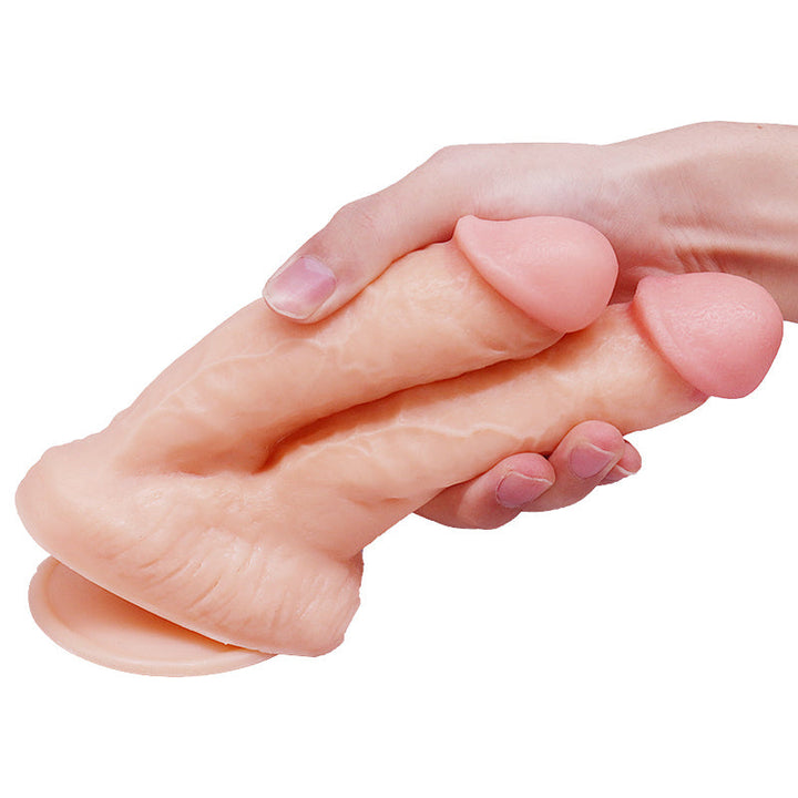 Hand hält doppelte Dildo-Sexpuppe