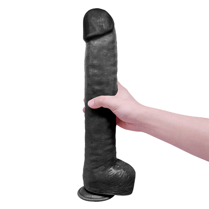 Hand hält große schwarze Dildo